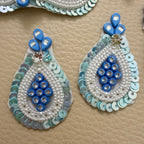 Blue pearl-look bead and sequin teardrop patch beside a ruler for size reference