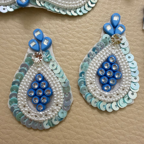 Blue pearl-look bead and sequin teardrop patch beside a ruler for size reference