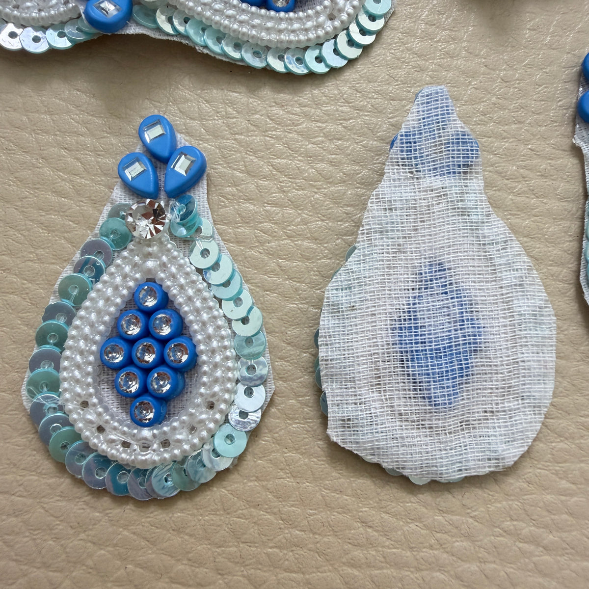 Group of blue embellished teardrop applique patches