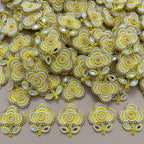 Yellow embellished flower patch held in a hand for scale