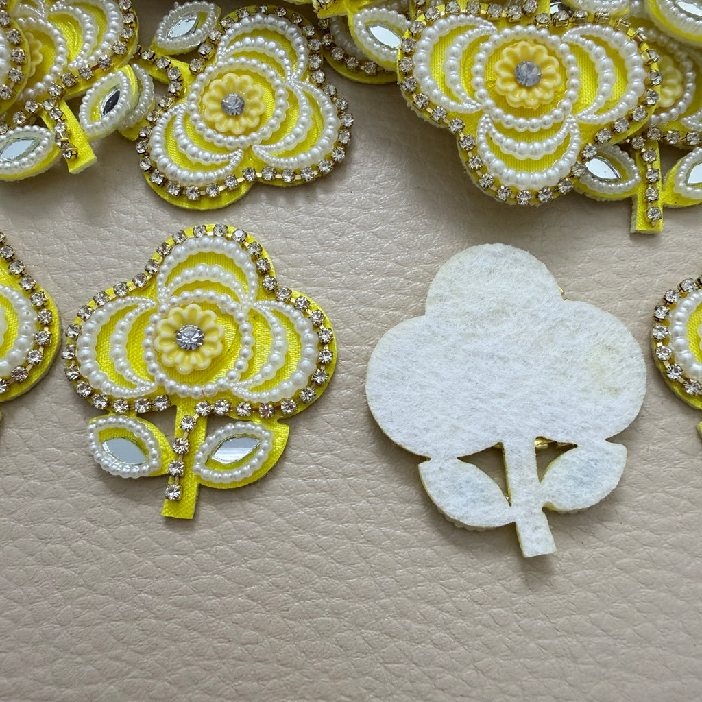 Front and white fabric backing of yellow floral applique patch