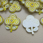 Front and white fabric backing of yellow floral applique patch