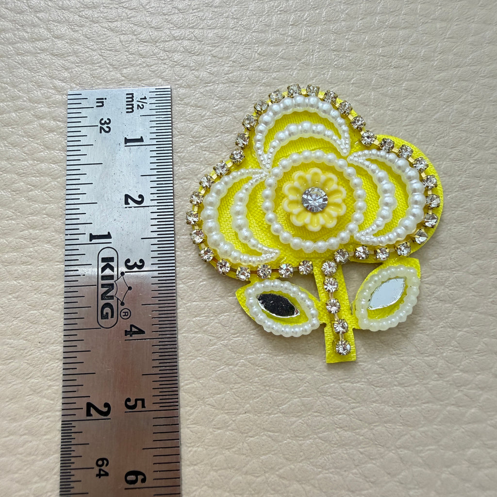 Yellow floral patches with white pearl-look beads, sparkling borders and reflective leaf details