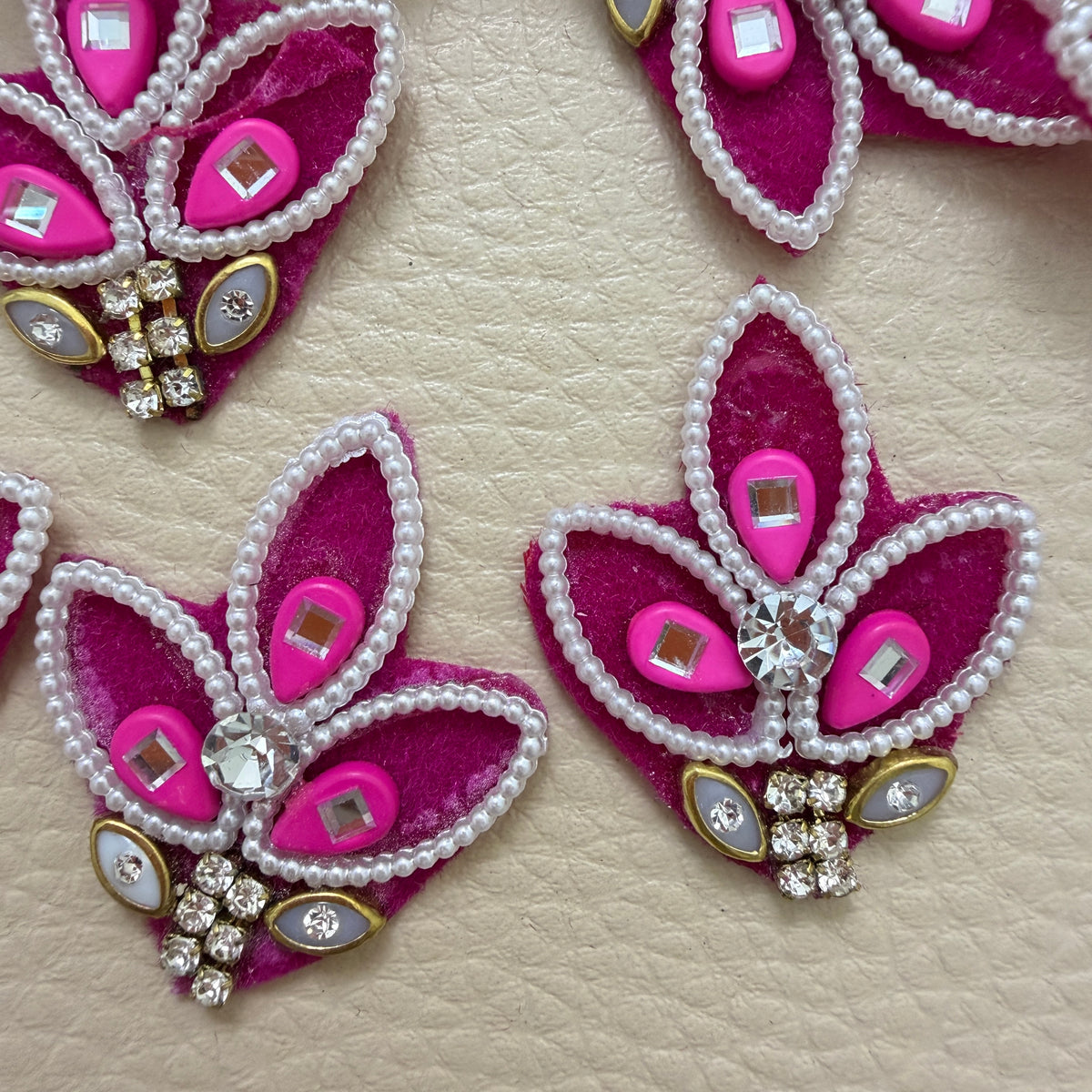 Pink three-leaf motif patches with white pearl-look borders and sparkling clear stones