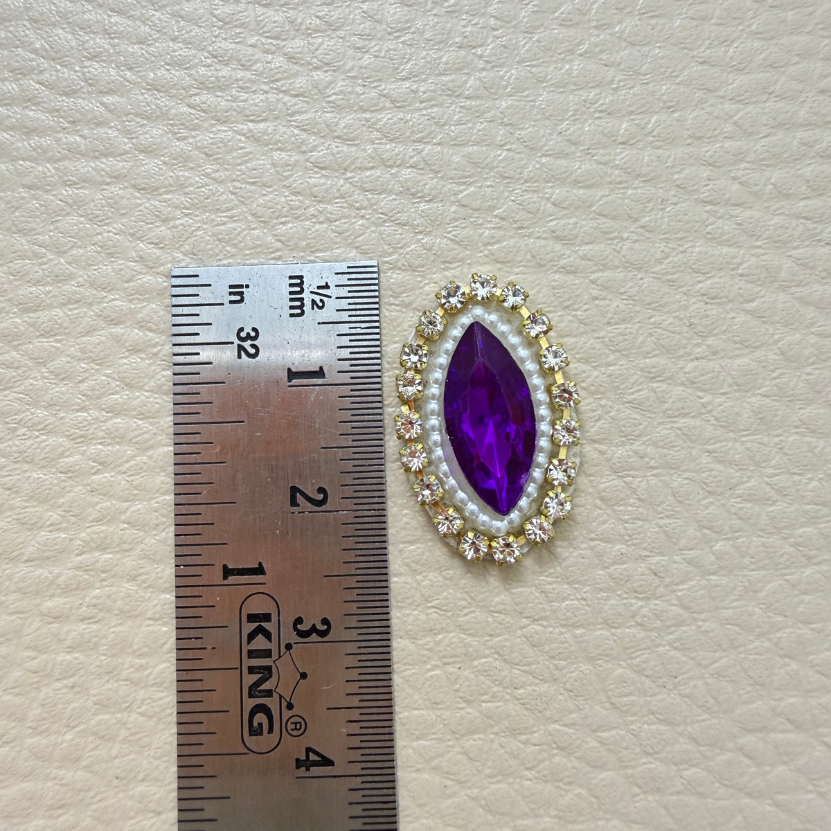 Purple marquise patch held in a hand for scale