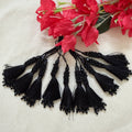 Black beaded tassel latkan held in hand showing size