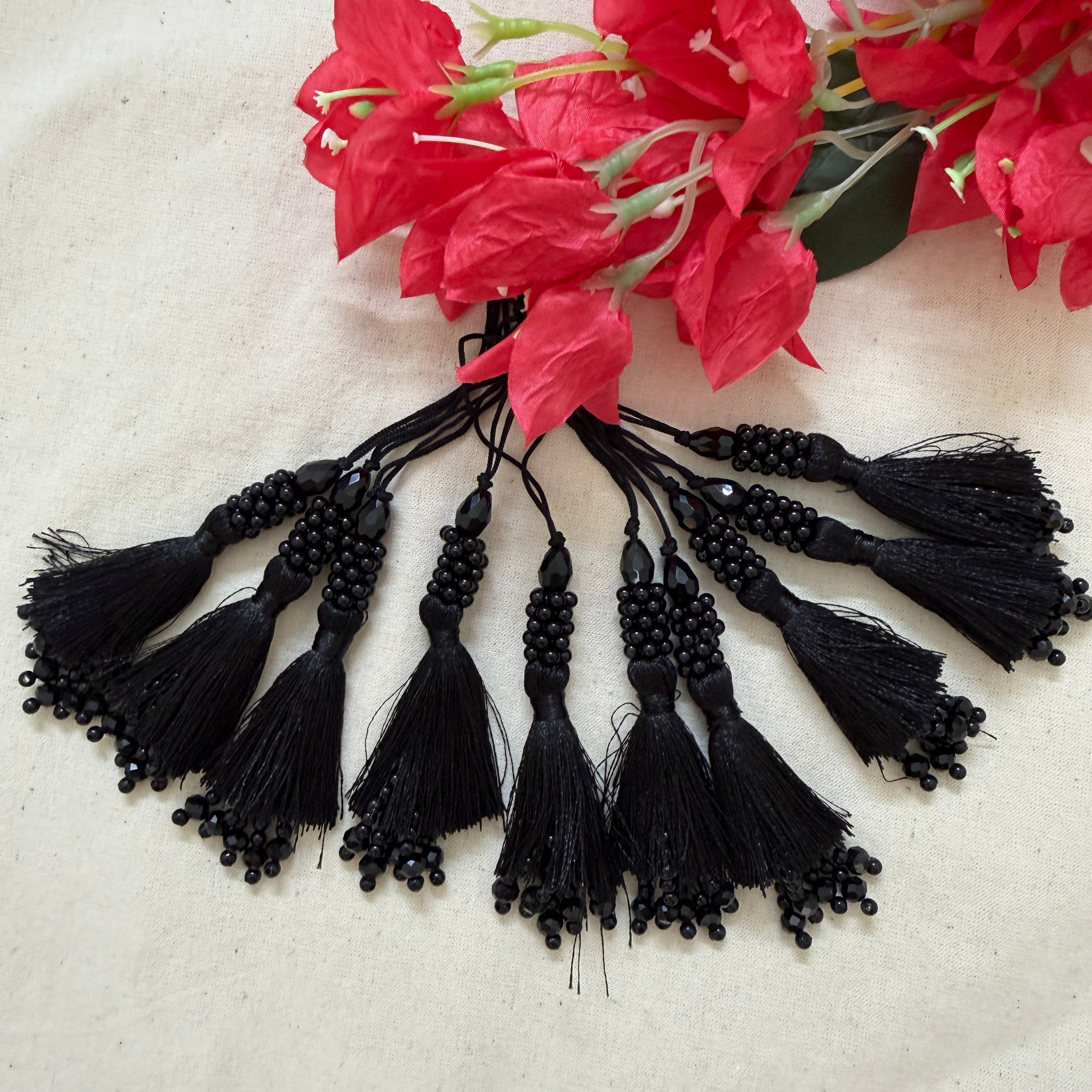 Black beaded tassel latkan held in hand showing size