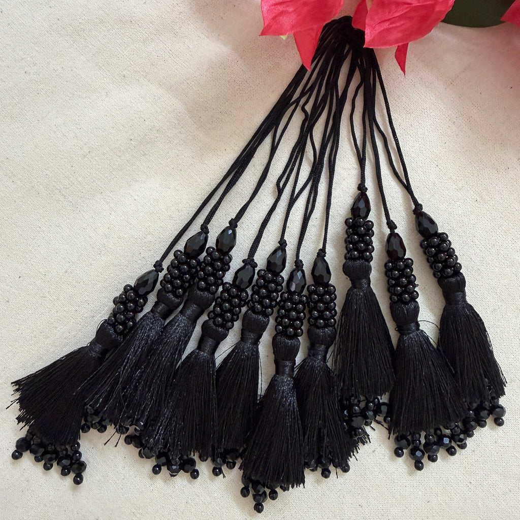 Black beaded tassel latkan next to ruler showing approx 14cm length