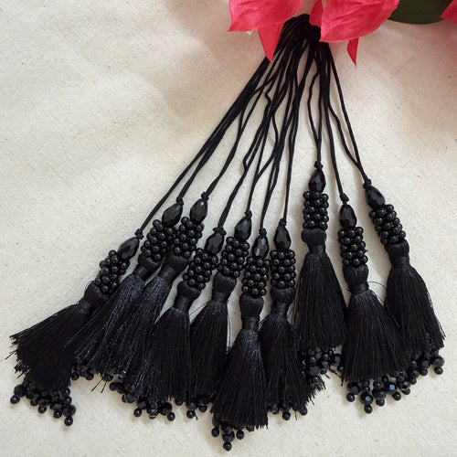 Black beaded tassel latkan next to ruler showing approx 14cm length