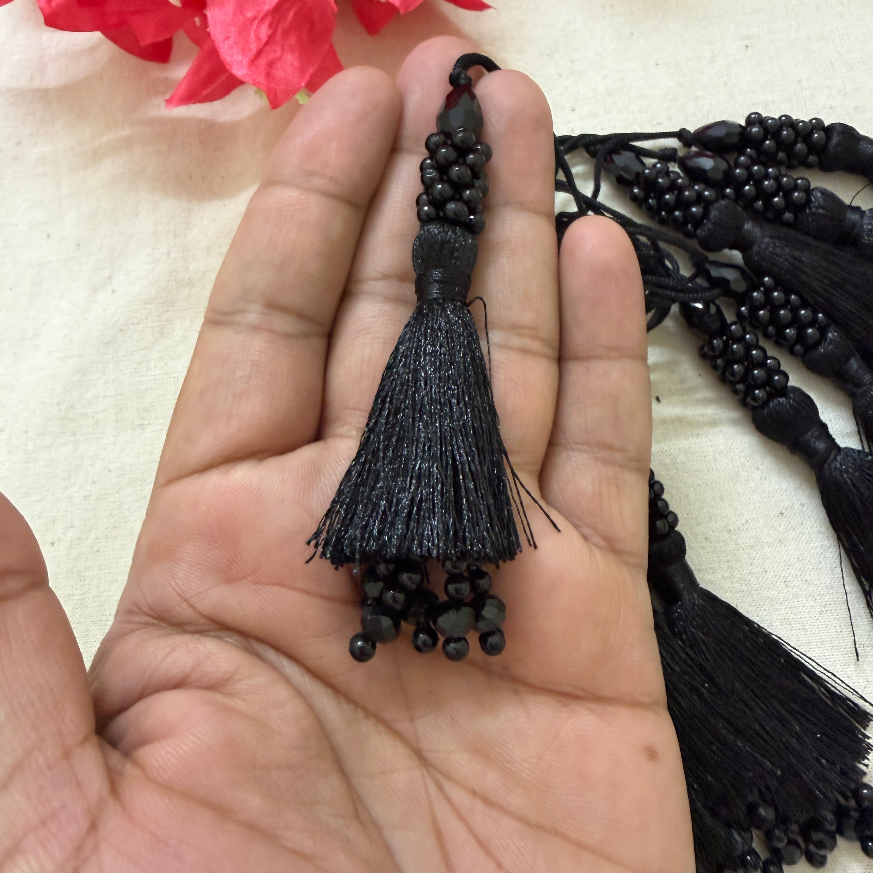 Multiple black beaded tassel latkans fanned out with flowers