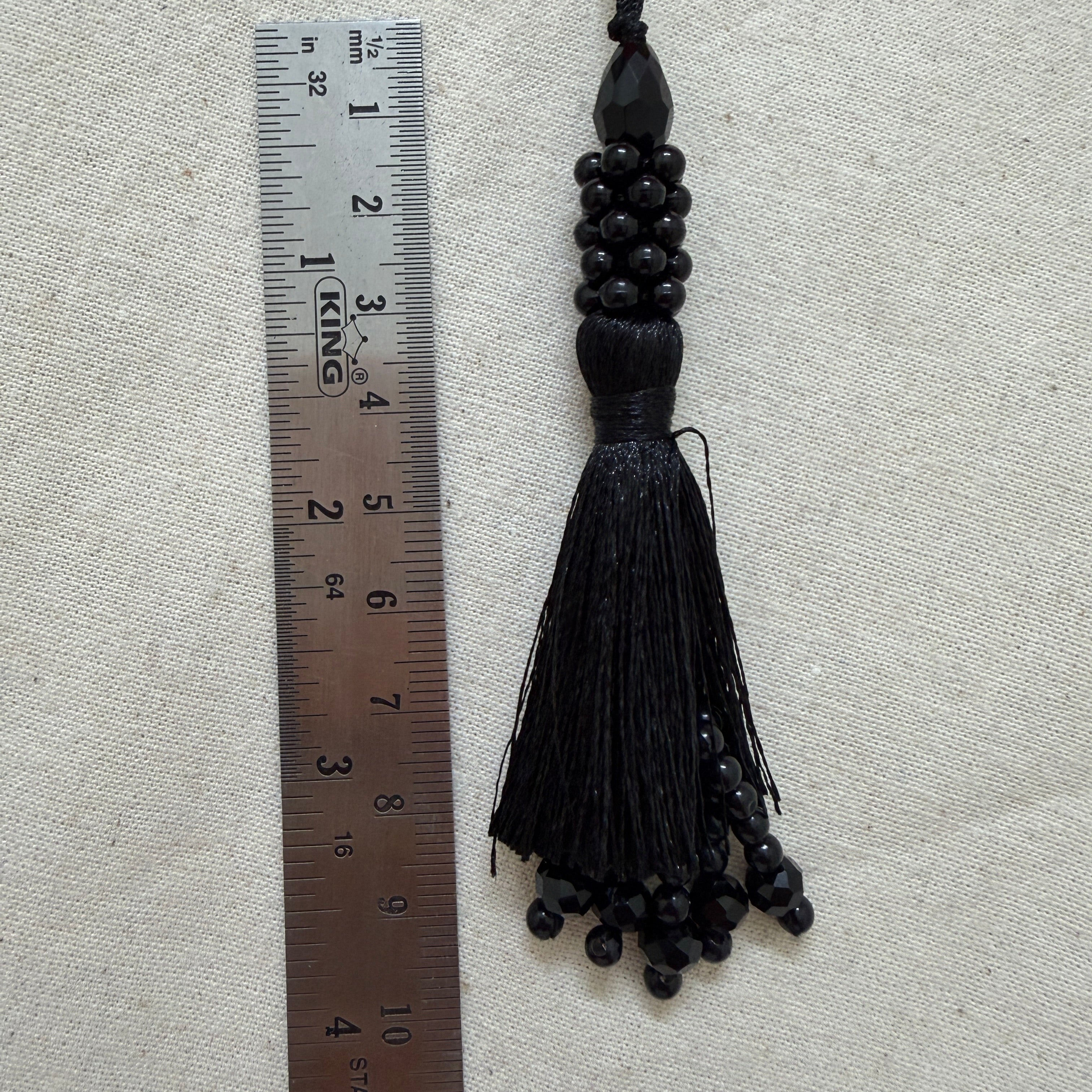 Pack of black beaded tassel latkans laid flat