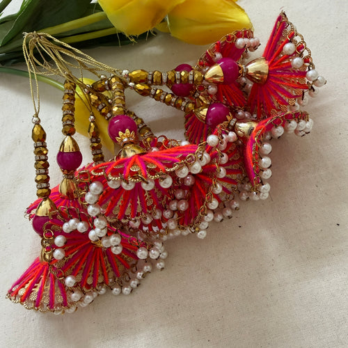 Fan tassel latkans laid flat with yellow flowers showing detail