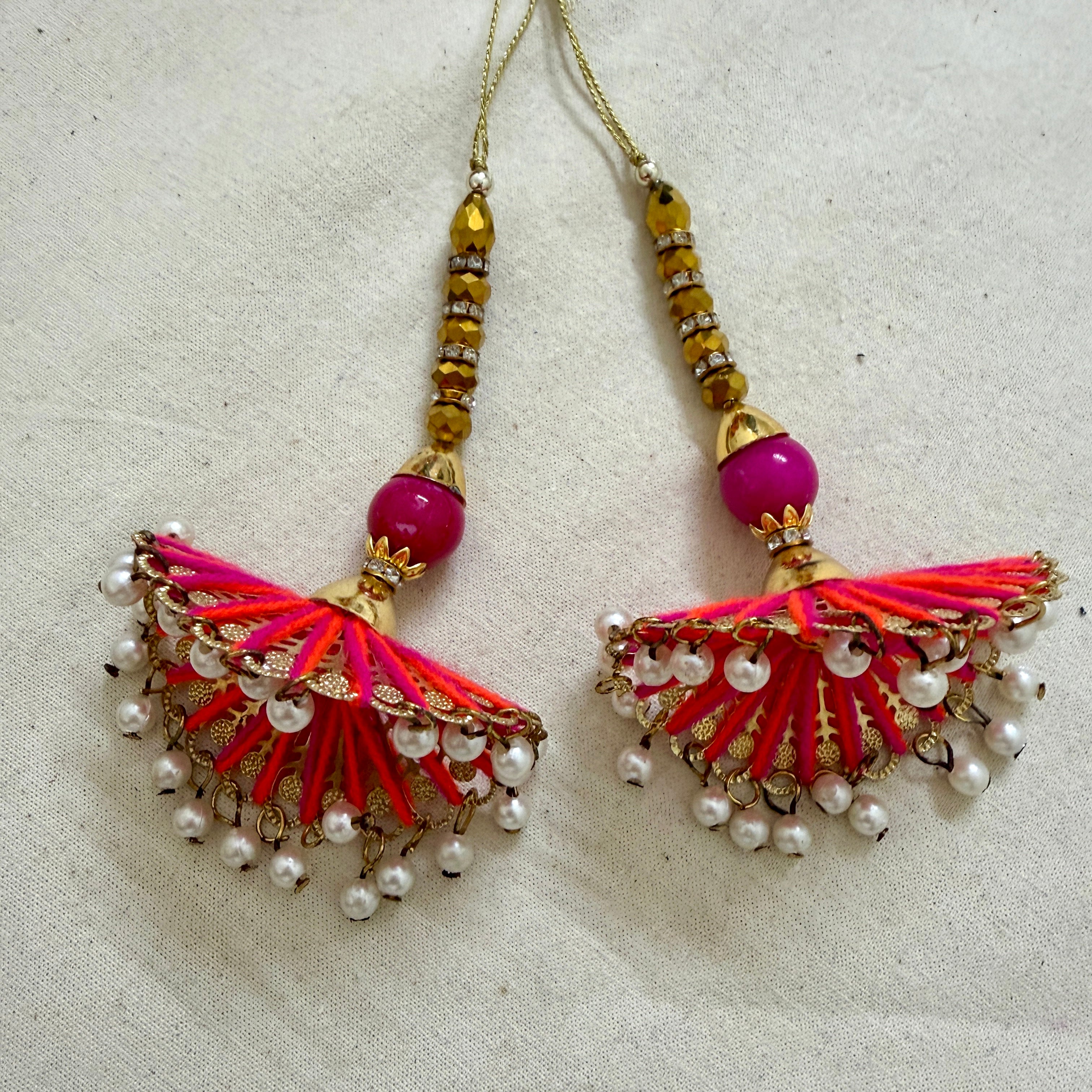 Pair of fan tassel latkans laid flat showing front detail