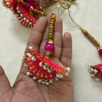 Single fan tassel latkan held in hand showing size