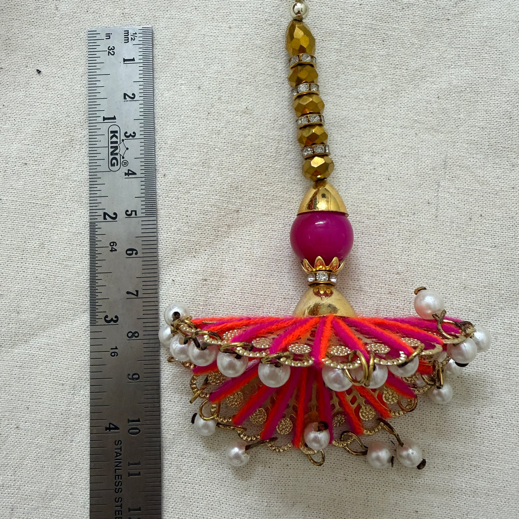 Single fan tassel latkan next to ruler showing approx 18cm length