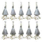 10 silver silk tassels with cowrie shells and pearl beads on white background