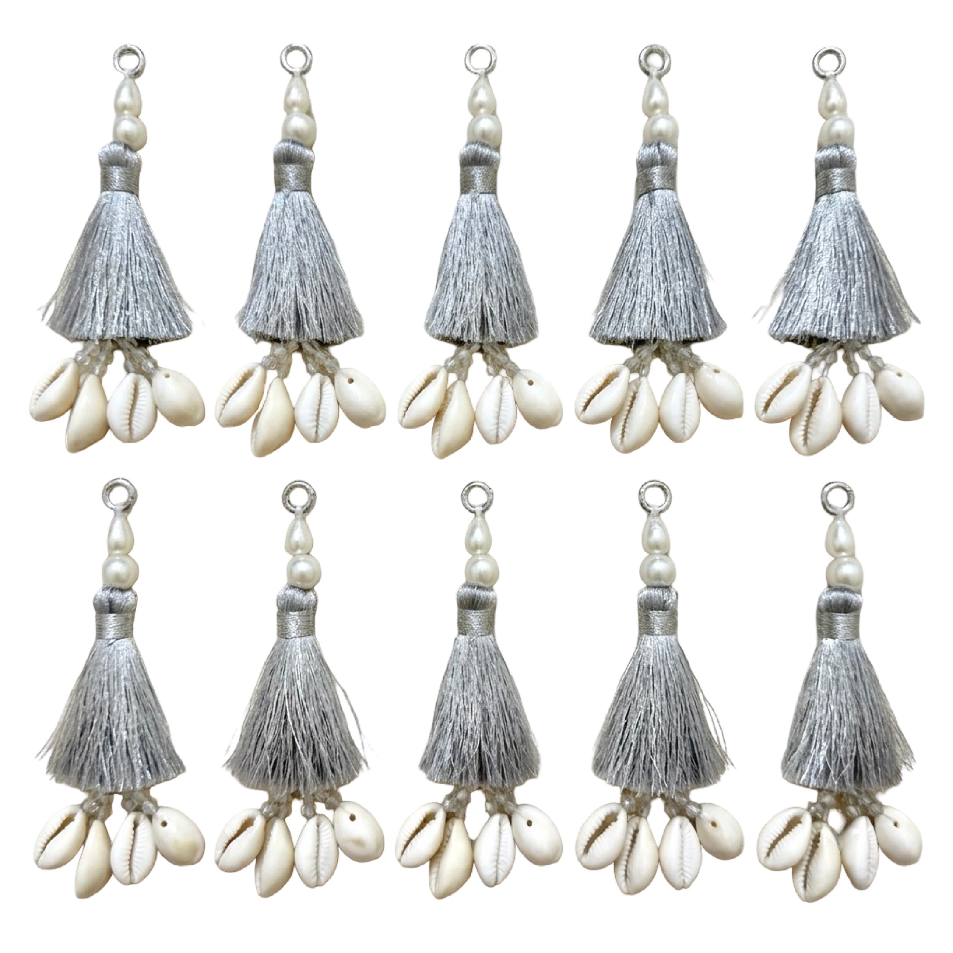 10 silver silk tassels with cowrie shells and pearl beads on white background