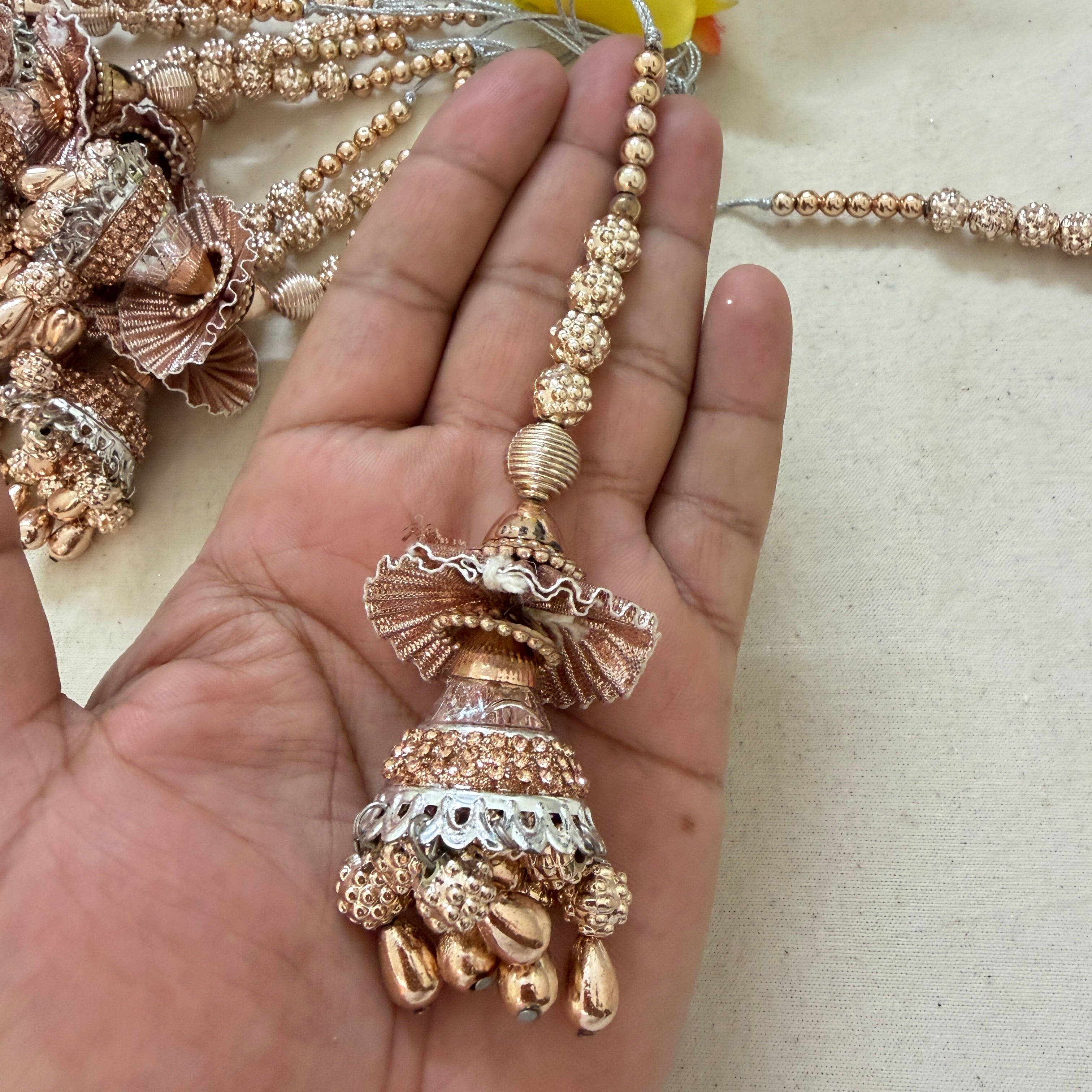 Rose Gold Jhumka Tassel held in hand showing size and detail