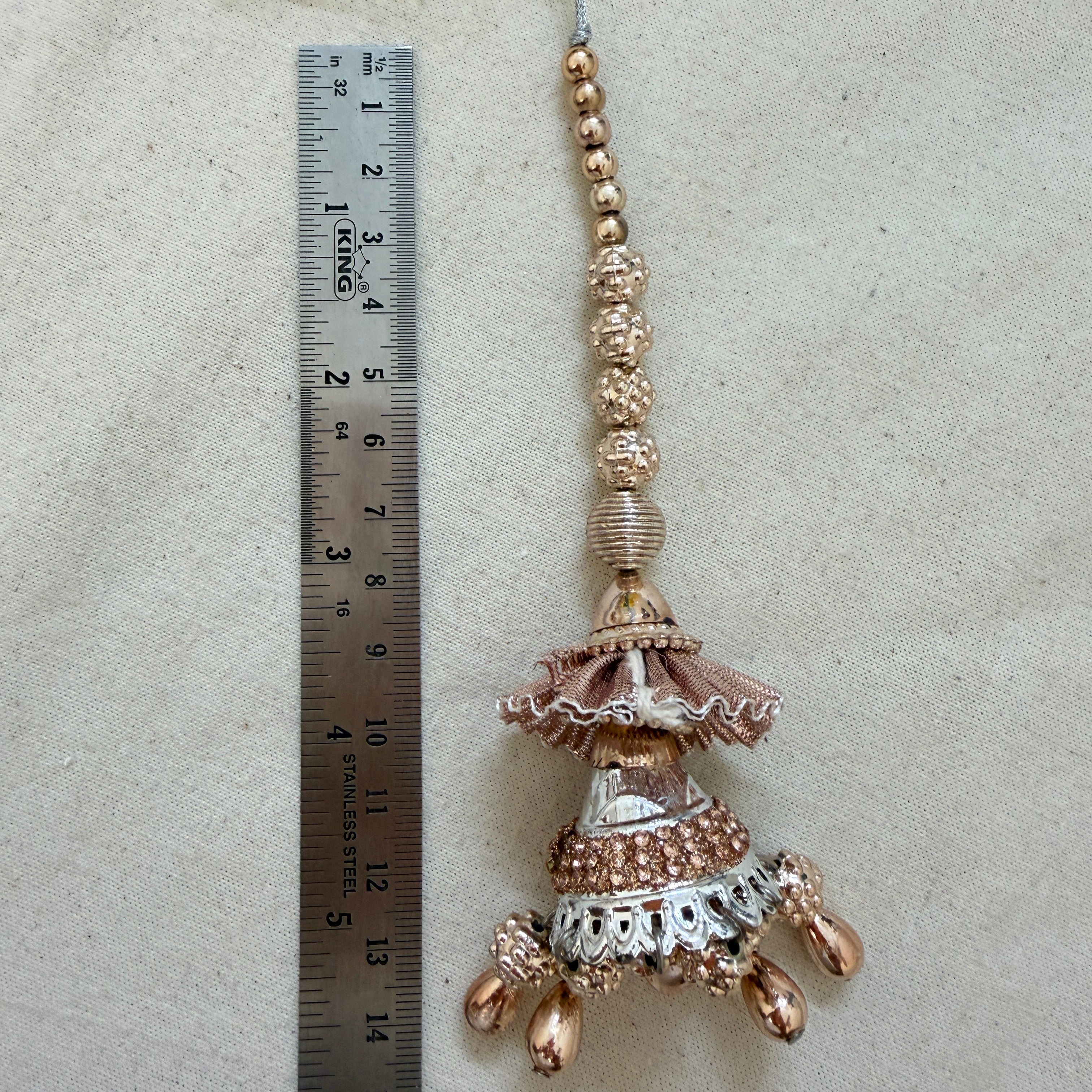 Pack of 2 Rose Gold Jhumka Tassels laid flat