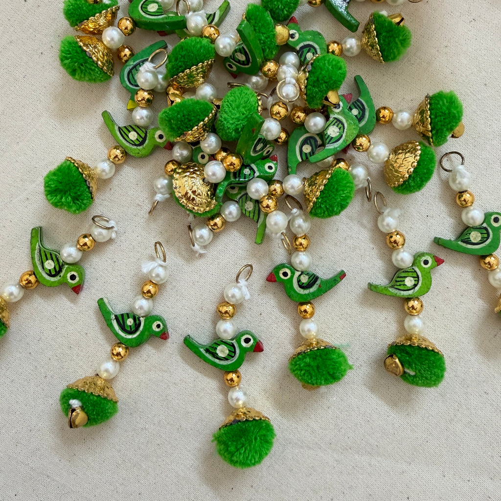 Pack of 10 Green Parrot Pom Pom Tassels on white background