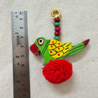 Red Parrot Pom Pom Tassel with ruler showing approx 8cm length