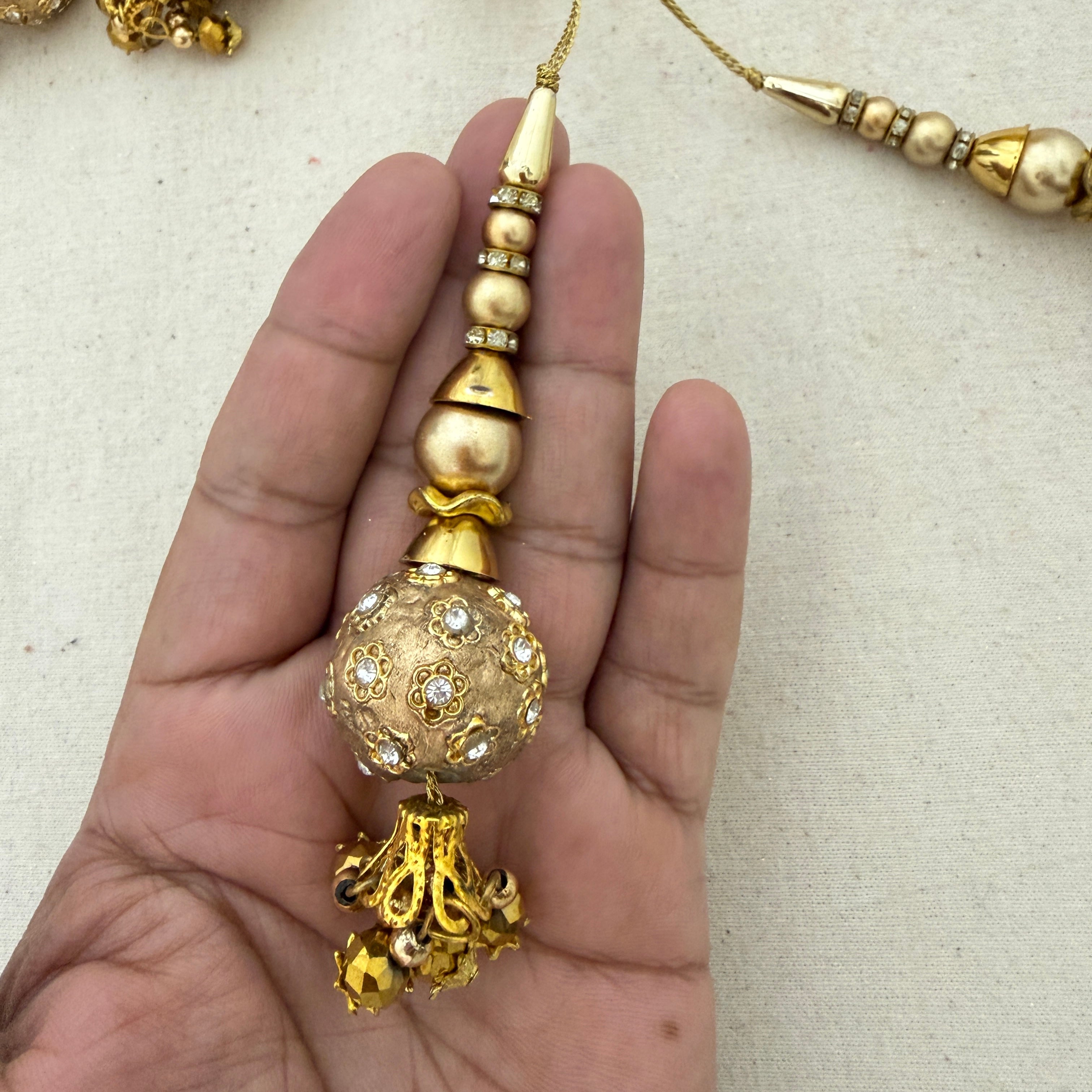 Rhinestone Floral Ball Latkan held in hand showing size and detail
