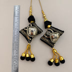 Group view of black and gold sequin cushion latkan tassels; sold in packs of two