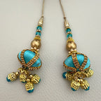 Pair of turquoise and gold-tone beaded latkan tassels with dangling charms, SKU TSL1224