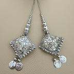 Pair of silver and white diamond-shaped latkan tassels with floral embellishments, beaded cords and dangling coin charms