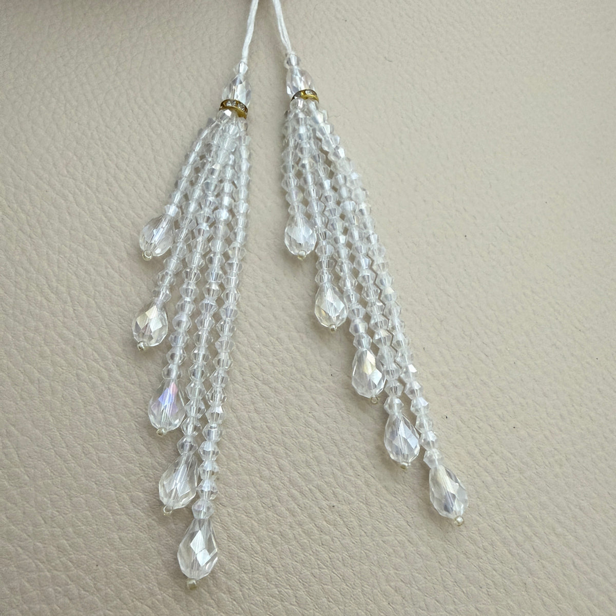 Clear beaded tassel beside a ruler for visual size reference