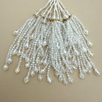 Clear faceted bead tassel held in a hand showing graduated strands and teardrop ends