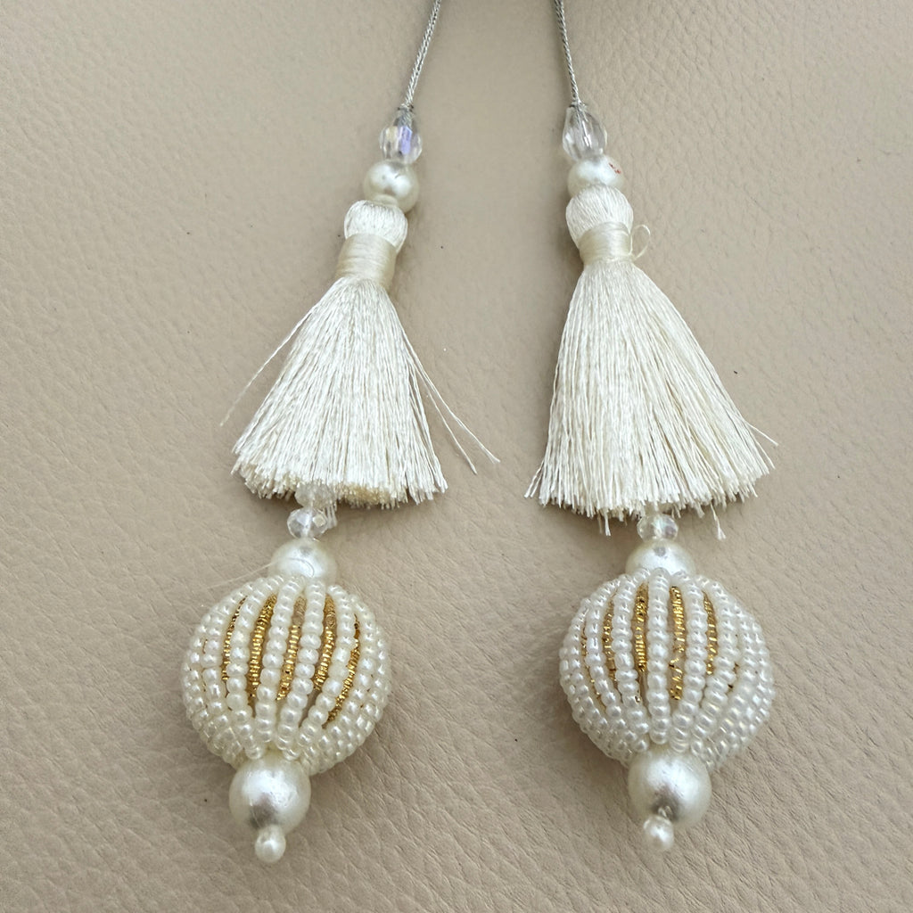 Group of ivory thread and pearl-look beaded ball tassels; each pack contains two pieces
