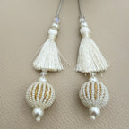 Group of ivory thread and pearl-look beaded ball tassels; each pack contains two pieces