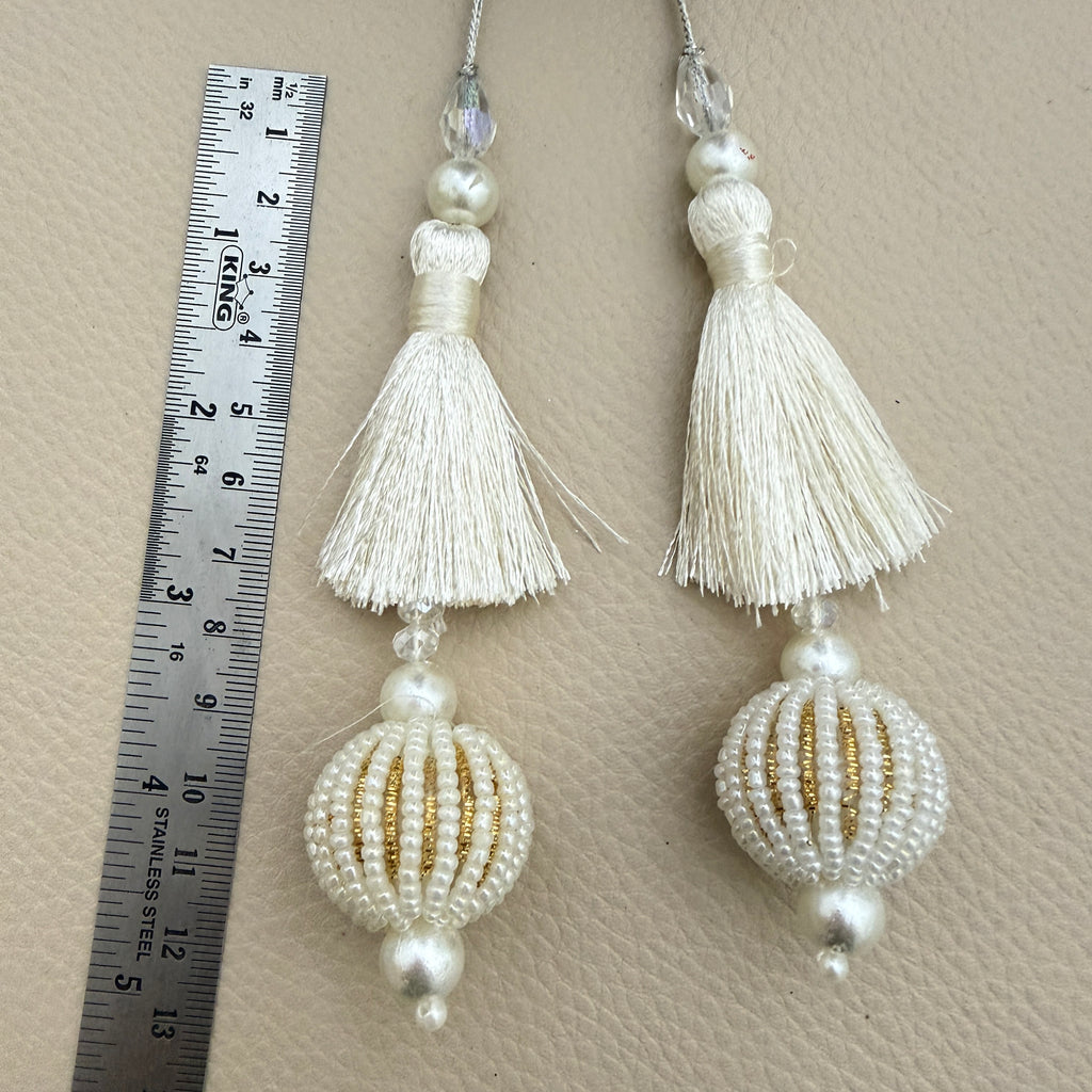 Pair of ivory thread latkan tassels with pearl-look beaded ball pendants and gold-tone detailing