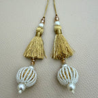 Group of gold thread tassels with pearl-look beaded balls; each pack contains two pieces