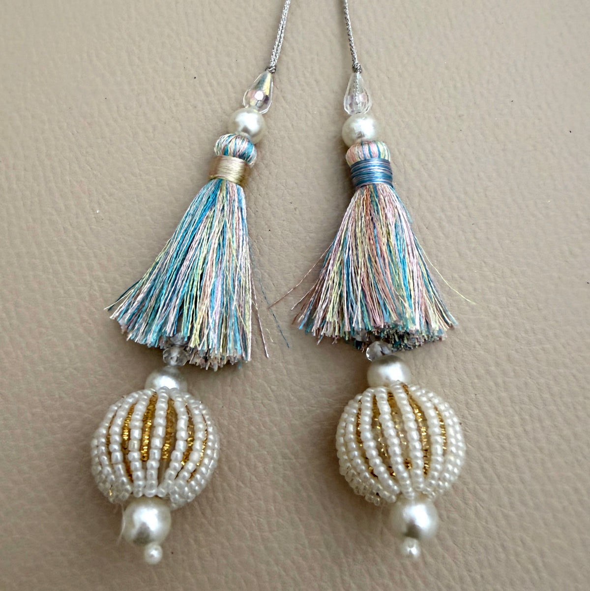 Group of pastel multicolour thread and pearl-look beaded ball tassels; each pack contains two pieces