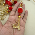 Pair of red pom pom latkan tassels with sparkling caps and gold-tone beaded chain drops