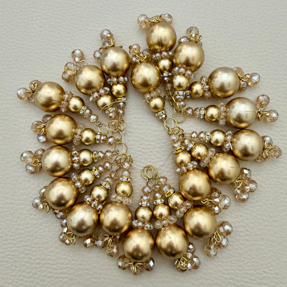 Gold-tone beaded latkan tassel TSL-1234 beside a ruler for size reference