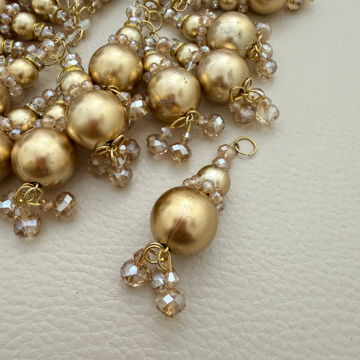 Gold-tone beaded latkan tassels arranged in a circle; sold as a pack of two